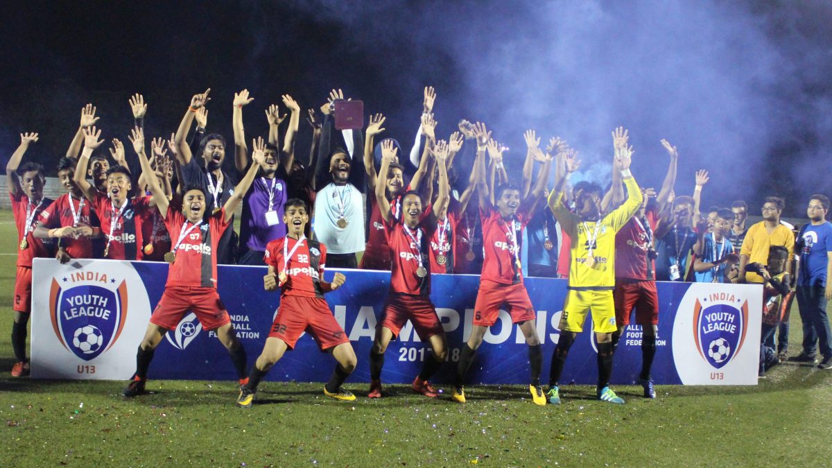 Players and officials celebrating after winning a Youth I-League title