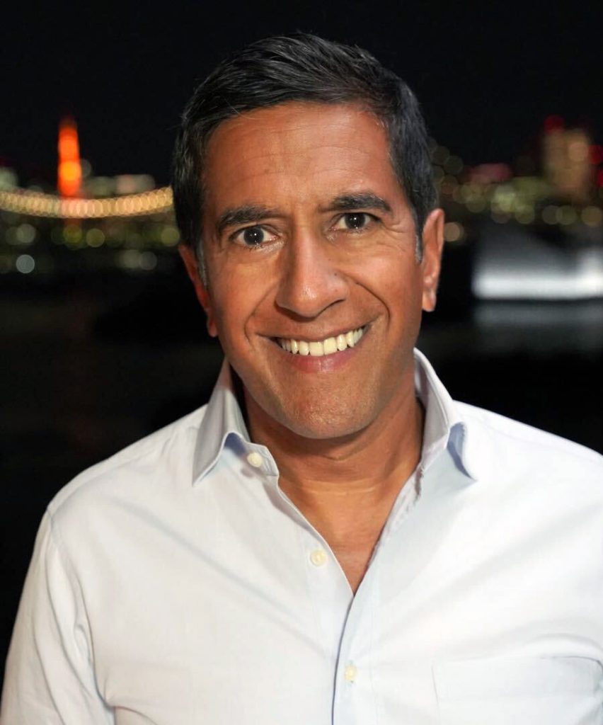 Sanjay Gupta smiling, in a dark shirt