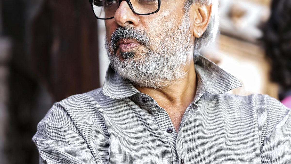 Sanjay Leela Bhansali with grey hair and beard, wearing glasses