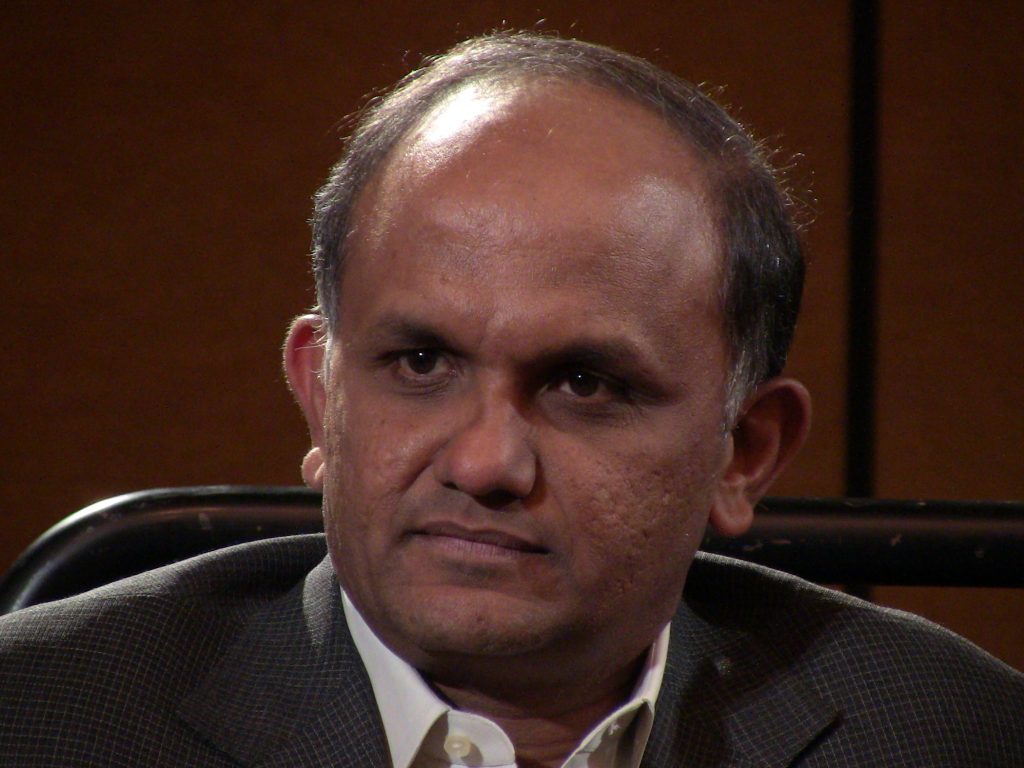 Close-up of Shantanu Narayen in a dark jacket looking to one side
