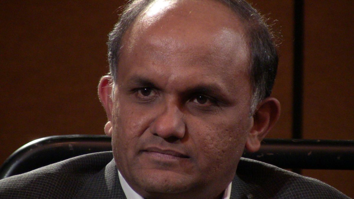 Close-up of Shantanu Narayen in a dark jacket looking to one side
