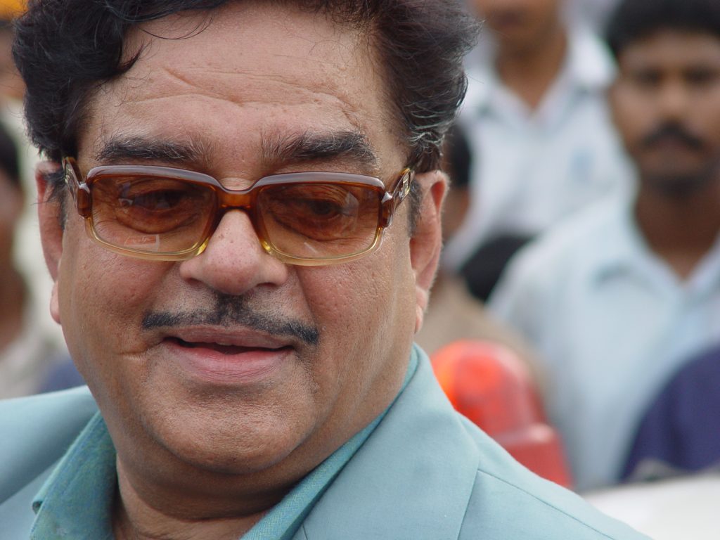 Close-up of Shatrughan Sinha with a moustache and tinted glasses, smiling