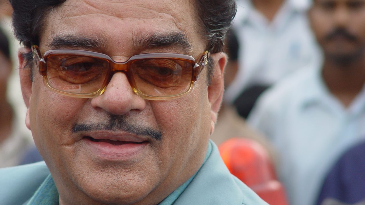 Close-up of Shatrughan Sinha with a moustache and tinted glasses, smiling