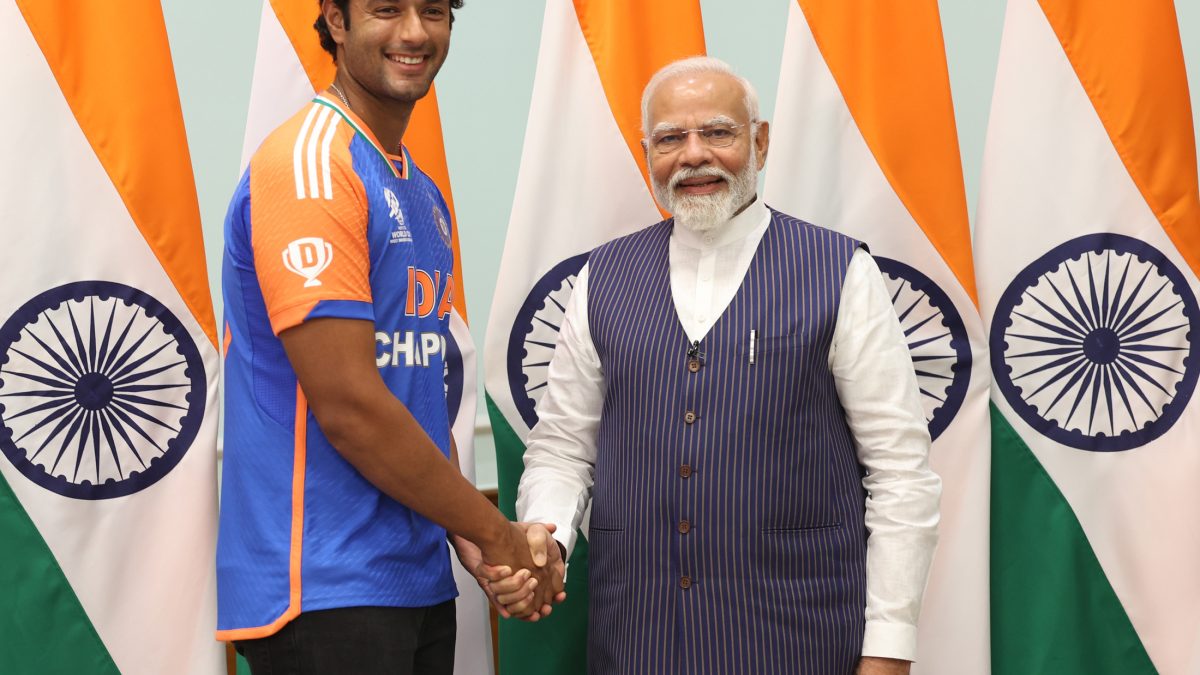 Shivam Dube in India's champions jersey shaking hands with Prime Minister Narendra Modi