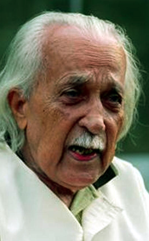 An elderly Shivaram Karanth with swept-back white hair and a white moustache, speaking