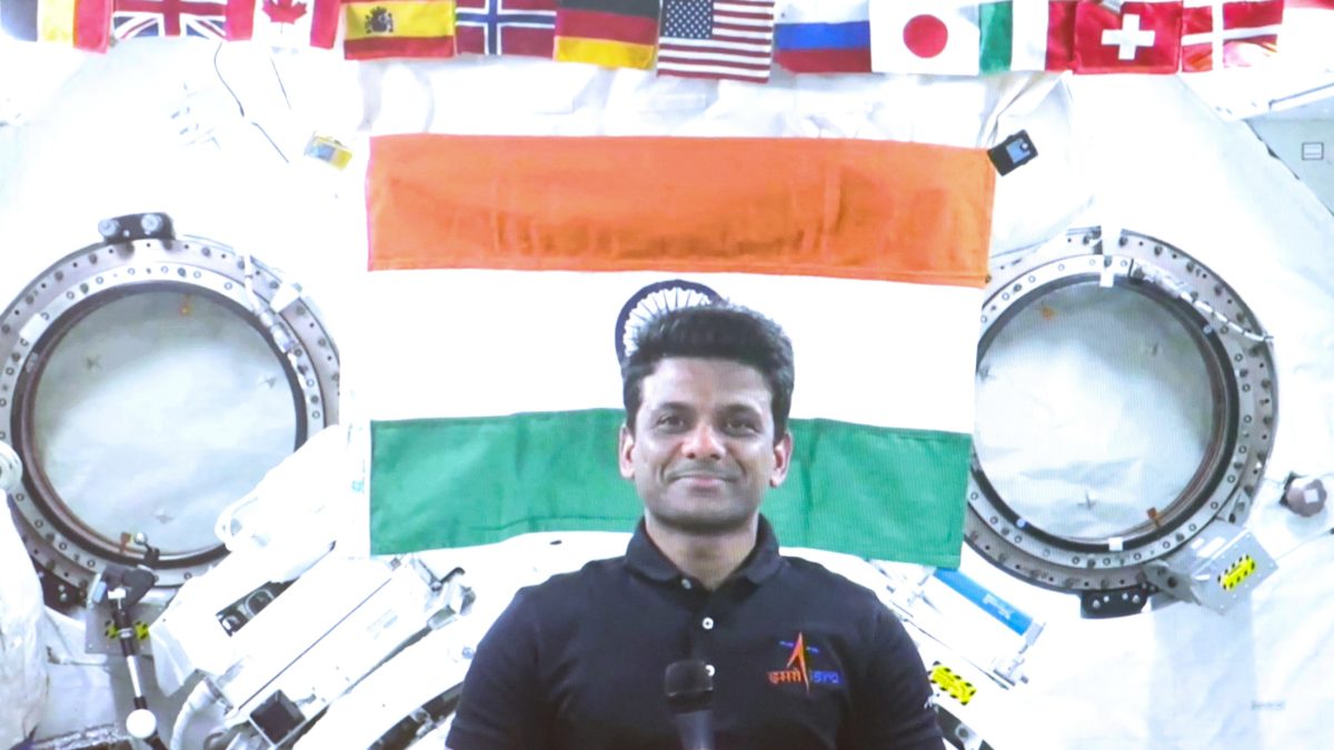 Shubhanshu Shukla smiling in front of the Indian flag aboard the International Space Station