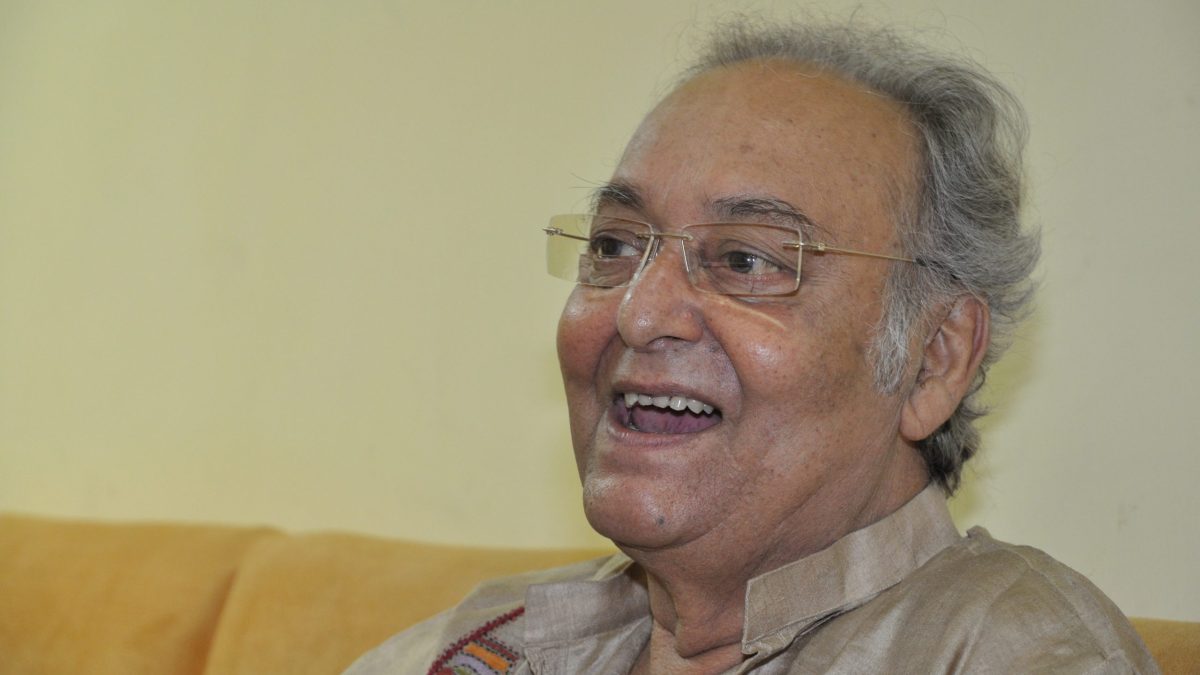 Soumitra Chatterjee with white hair, laughing, in a light kurta