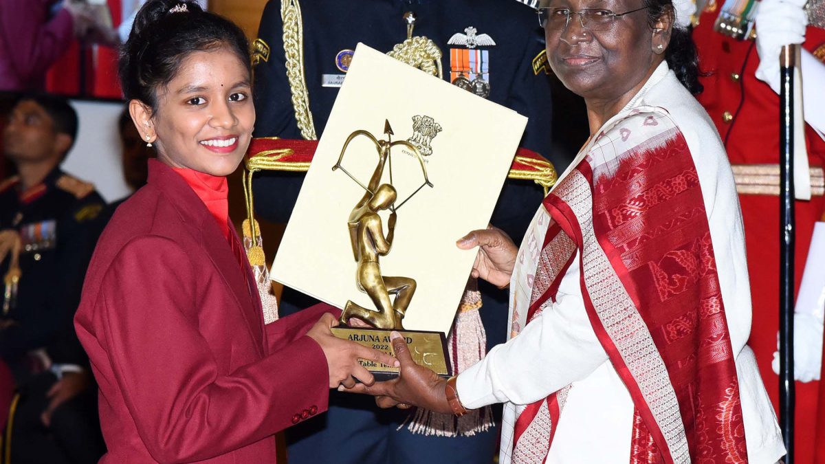Sreeja Akula in a maroon blazer receiving the Arjuna Award from President Droupadi Murmu