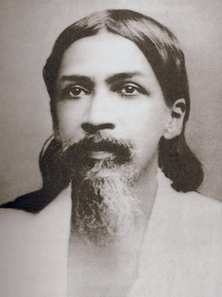 Portrait of the young Aurobindo Ghose with long hair and a beard