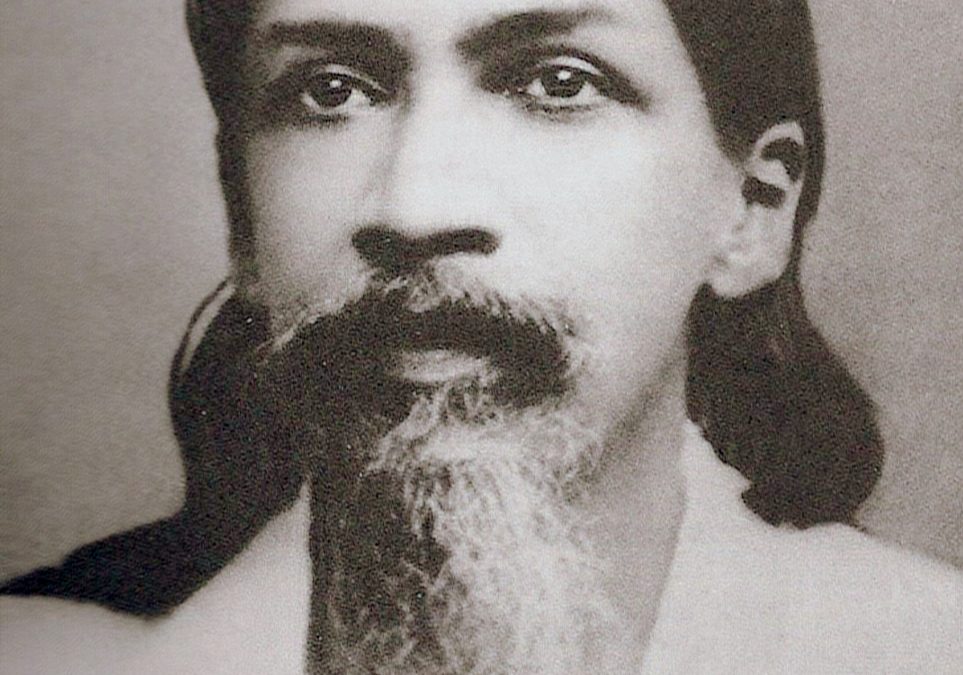 Portrait of the young Aurobindo Ghose with long hair and a beard