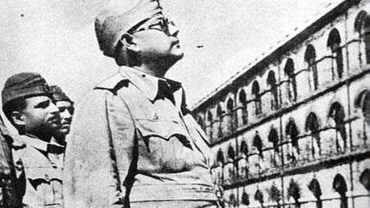 Subhas Chandra Bose in military uniform and cap looking upward