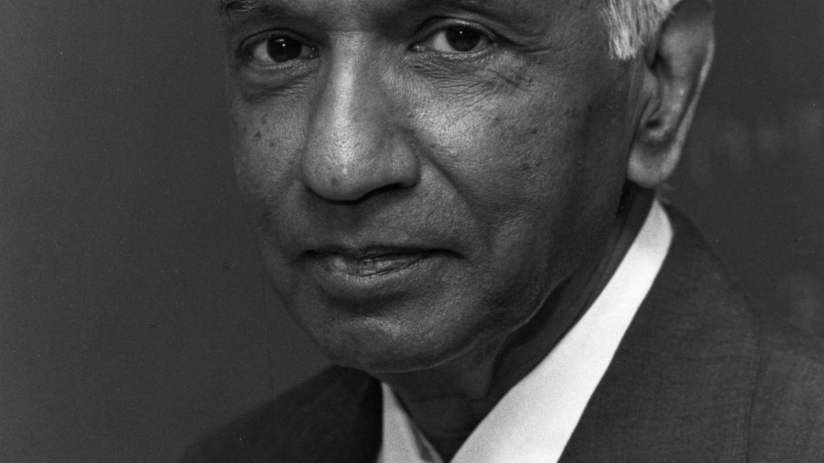 Black-and-white portrait of Subrahmanyan Chandrasekhar in a suit and tie