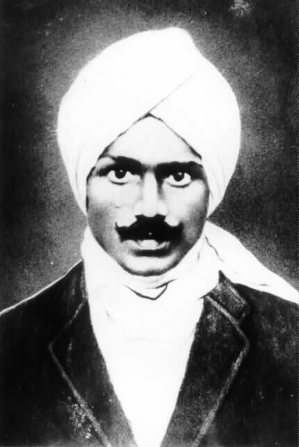 A black-and-white photograph of Subramania Bharati in a turban, with a moustache