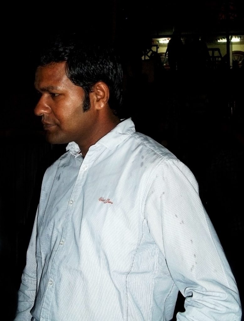 Sudarsan Pattnaik in a white shirt at an evening event