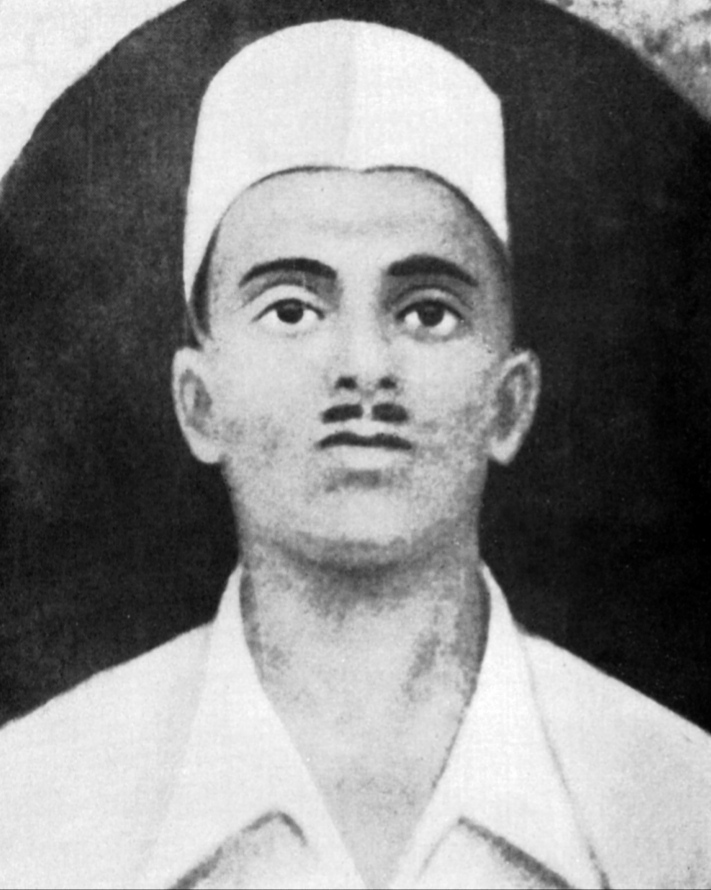 A black-and-white portrait of Sukhdev Thapar in a white cap