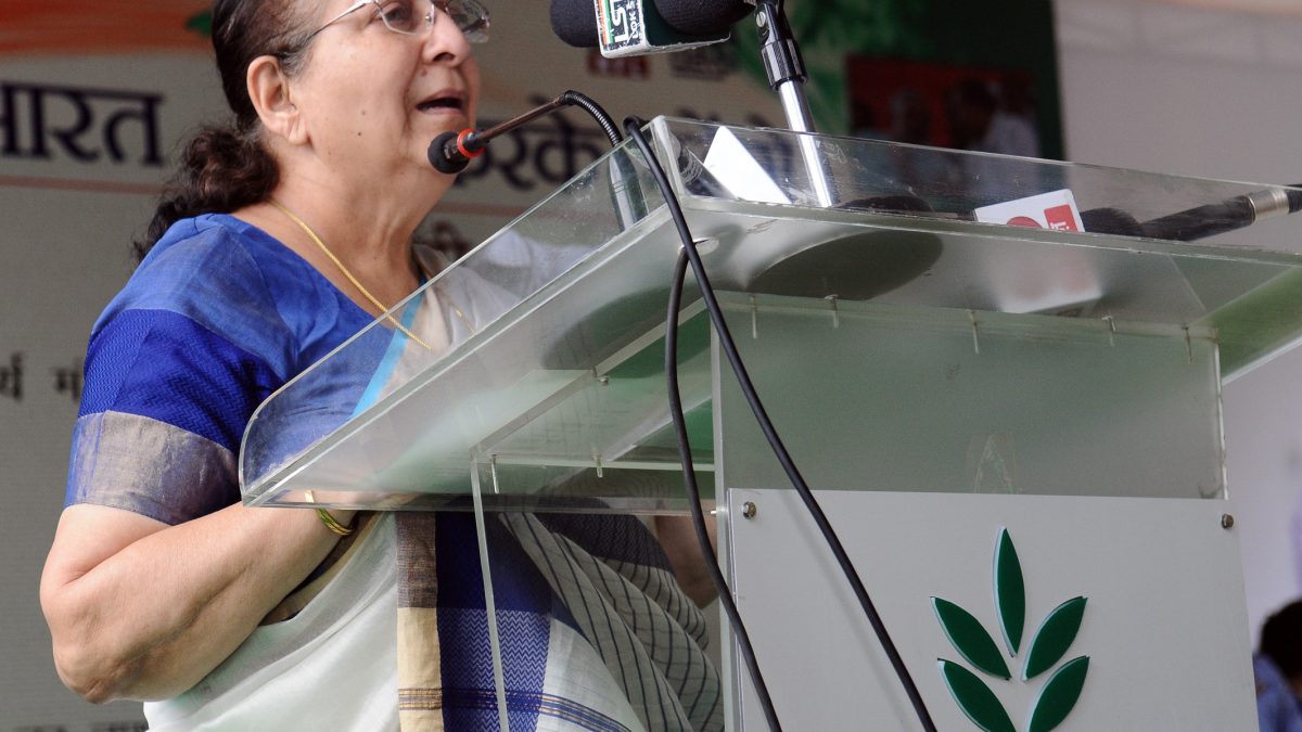 Sumitra Mahajan in a blue sari speaking at a lectern