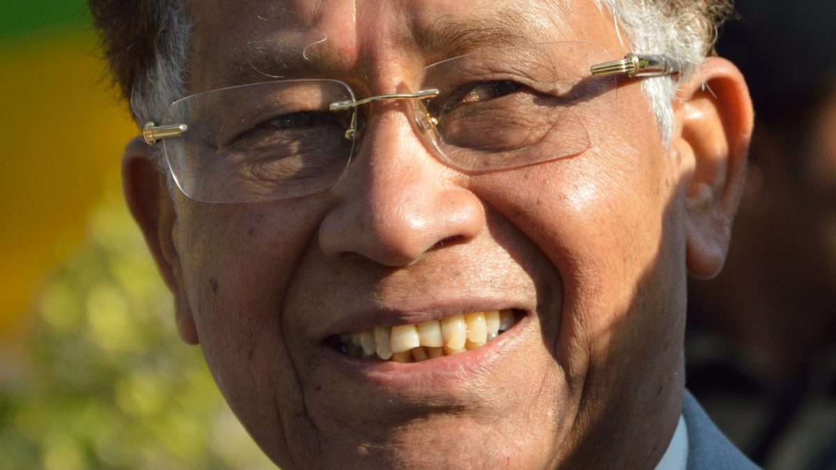 Tarun Gogoi in glasses and a dark jacket, smiling