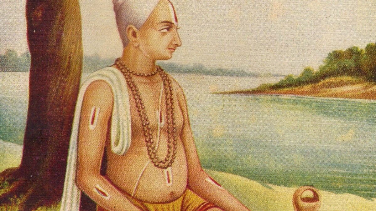 Painting of Tulsidas seated cross-legged under a tree beside a river, writing