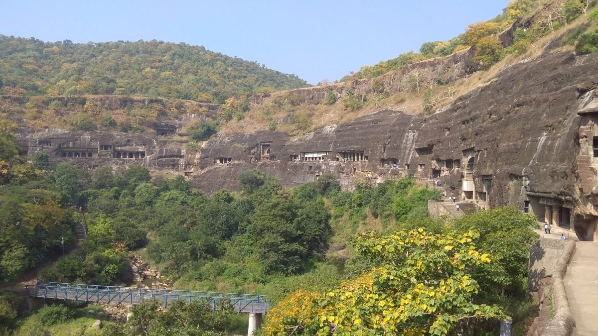 A view of the rock-cut Ajanta Caves in the cliff of the Waghora gorge
