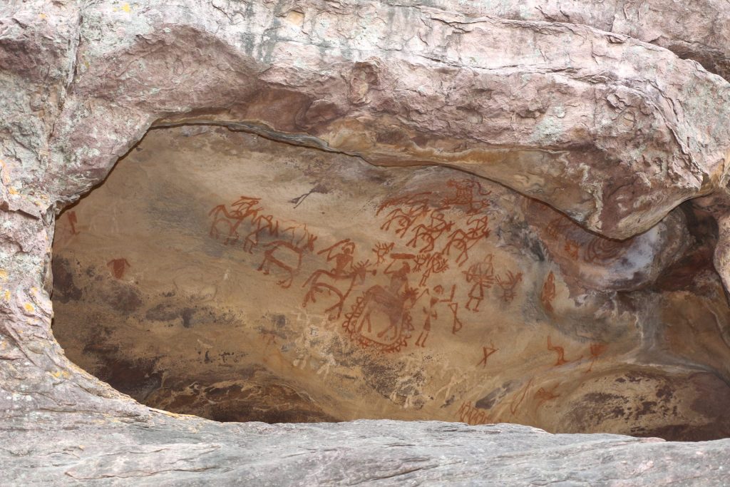 A sandstone rock shelter at Bhimbetka with prehistoric paintings on its wall