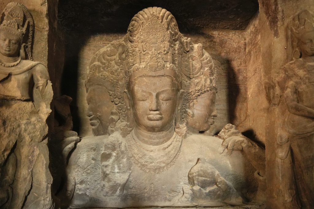 The colossal three-headed bust of Shiva carved in the rock inside the main cave at Elephanta