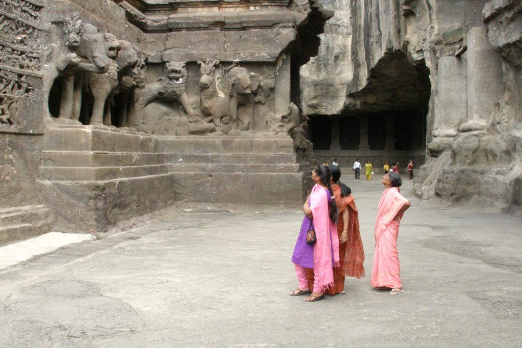 Visitors in the rock-cut courtyard of the Kailasa Temple at Ellora
