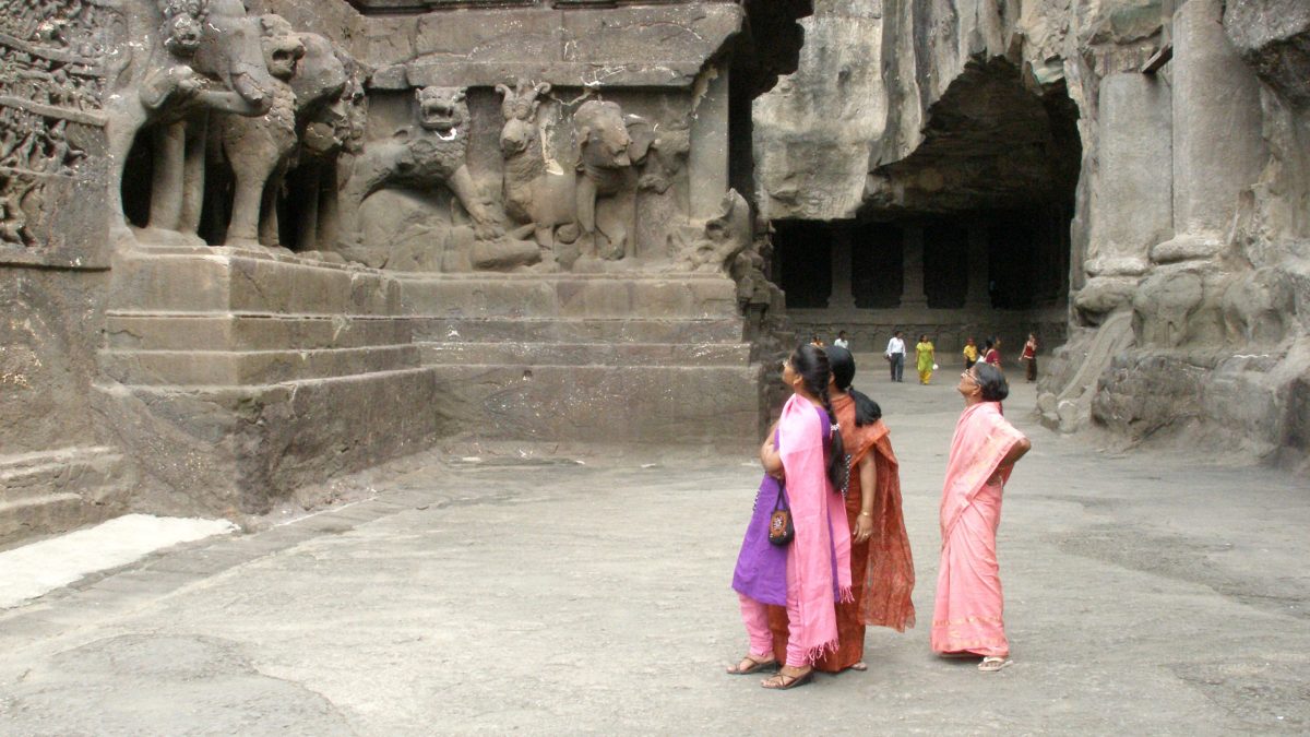 Visitors in the rock-cut courtyard of the Kailasa Temple at Ellora