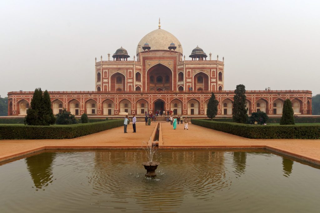 The red sandstone and white marble Humayun's Tomb with its large dome, seen across its garden