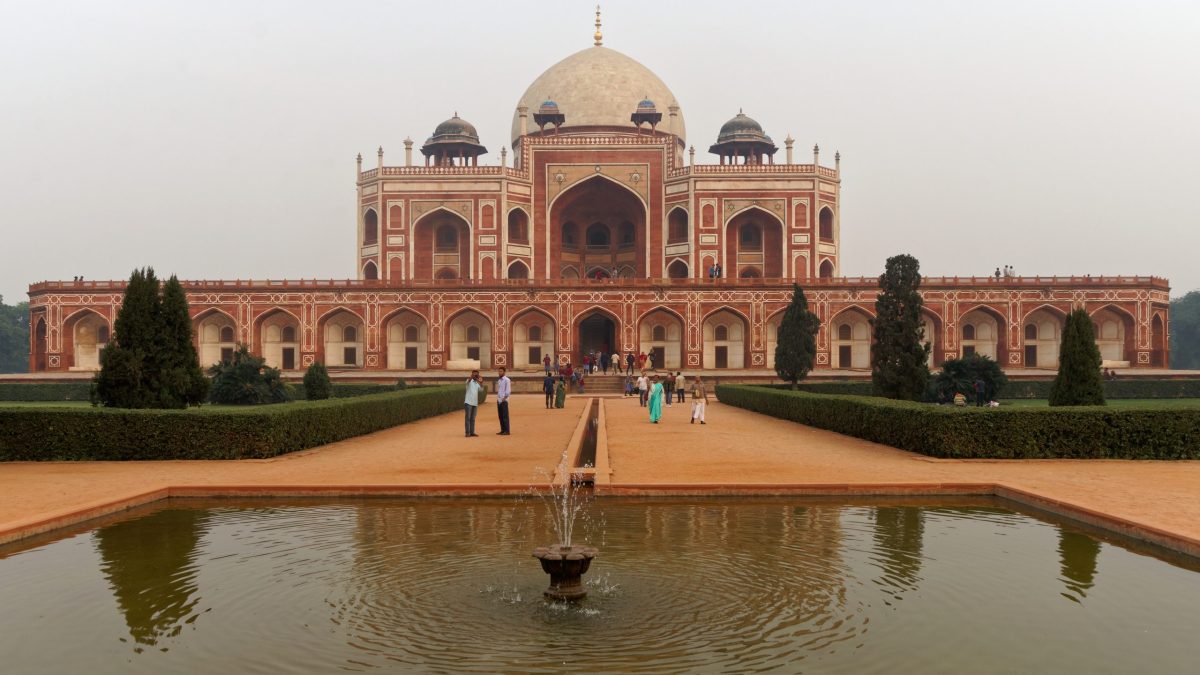 The red sandstone and white marble Humayun's Tomb with its large dome, seen across its garden