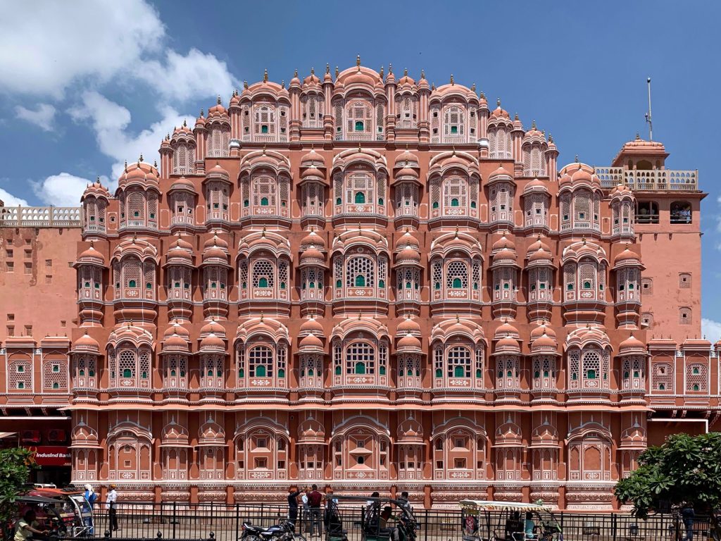 The pink sandstone facade of the Hawa Mahal in Jaipur with its rows of small latticed windows
