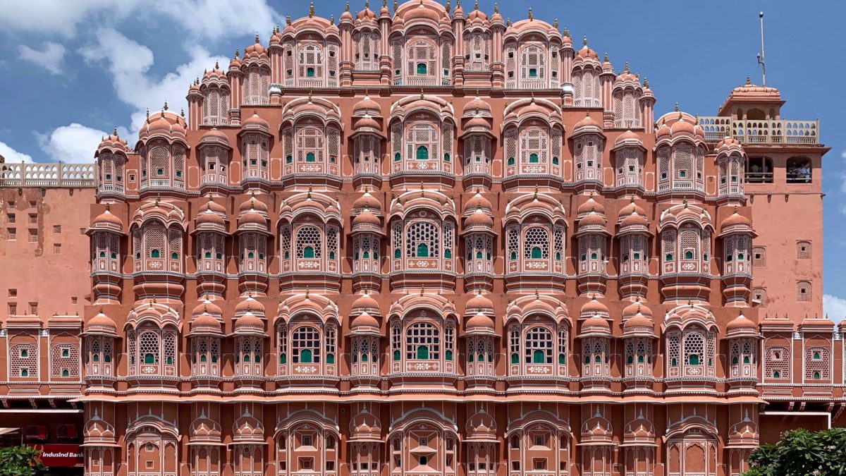 The pink sandstone facade of the Hawa Mahal in Jaipur with its rows of small latticed windows
