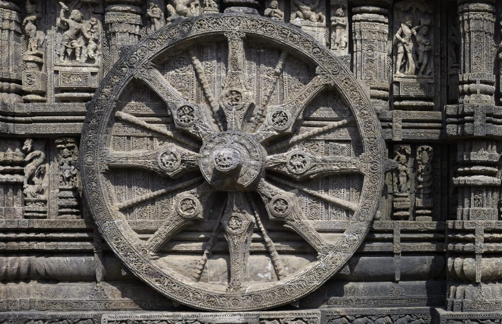 One of the large carved stone chariot wheels on the wall of the Sun Temple at Konark