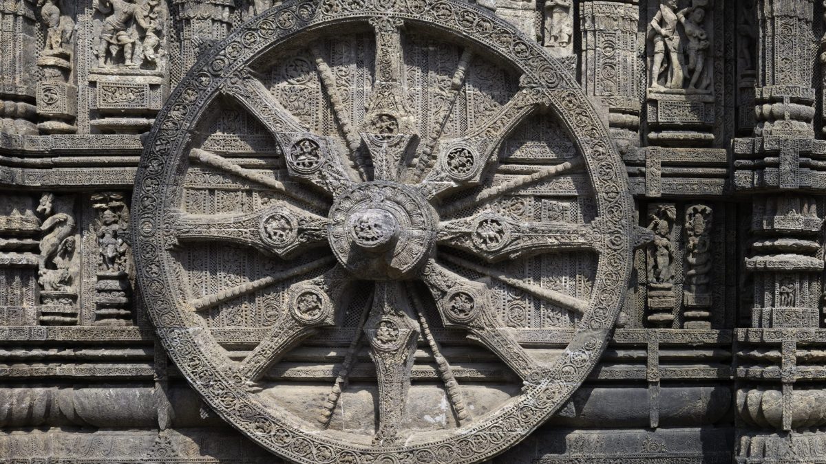 One of the large carved stone chariot wheels on the wall of the Sun Temple at Konark