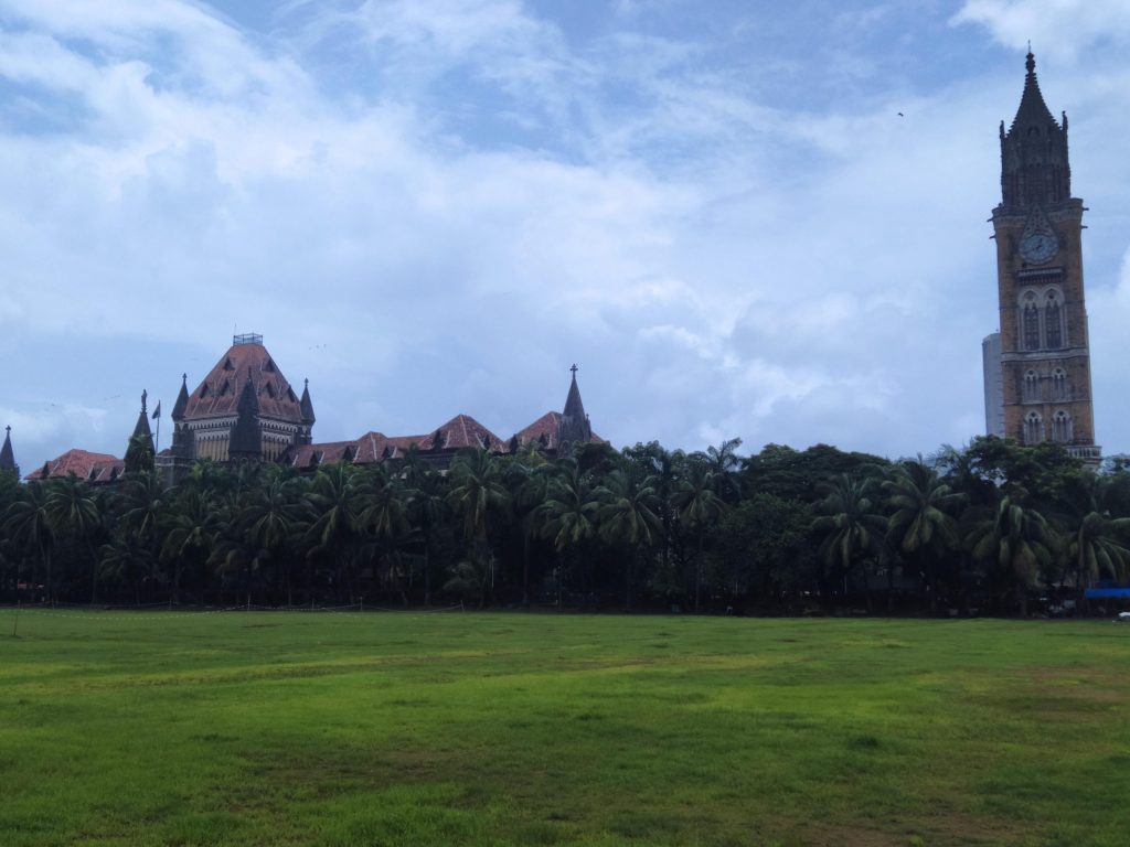 The Gothic buildings of the Bombay High Court and the Rajabai Clock Tower seen across the Oval Maidan in Mumbai