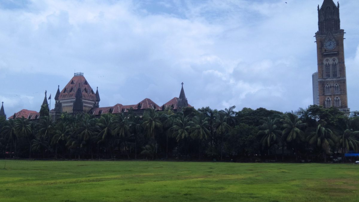 The Gothic buildings of the Bombay High Court and the Rajabai Clock Tower seen across the Oval Maidan in Mumbai