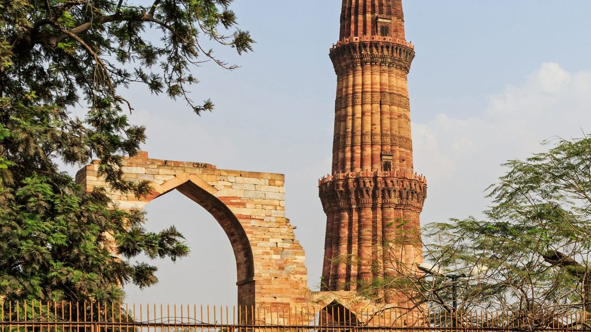 The tall fluted red sandstone tower of the Qutb Minar in Delhi with its projecting balconies