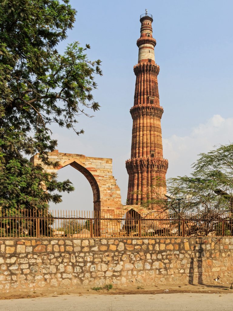 The tall fluted red sandstone tower of the Qutb Minar in Delhi with its projecting balconies