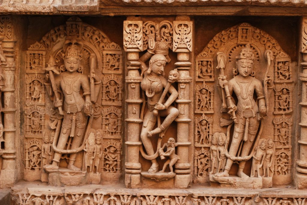 Rows of carved stone figures of deities on the wall of the Rani ki Vav stepwell at Patan