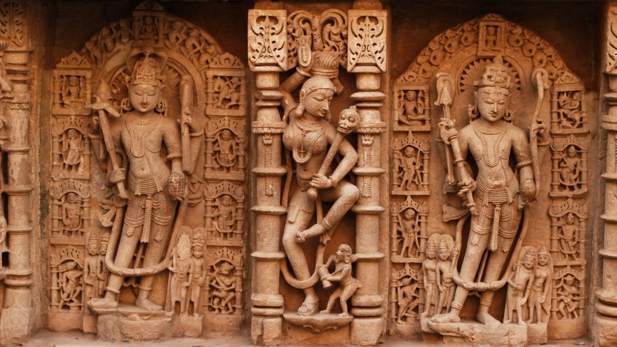 Rows of carved stone figures of deities on the wall of the Rani ki Vav stepwell at Patan