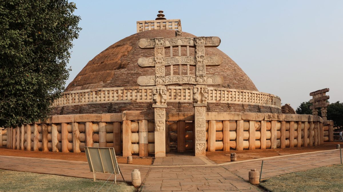 The hemispherical dome of the Great Stupa at Sanchi with its stone railing and carved gateway