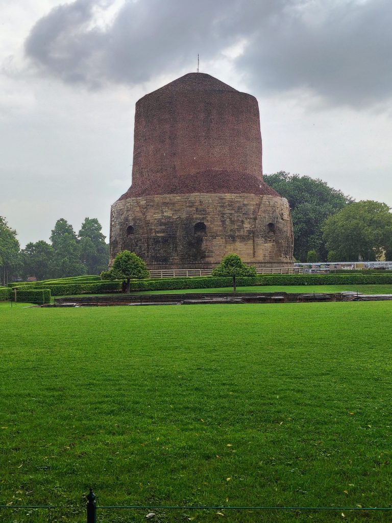 The massive cylindrical Dhamek Stupa at Sarnath built of brick and carved stone