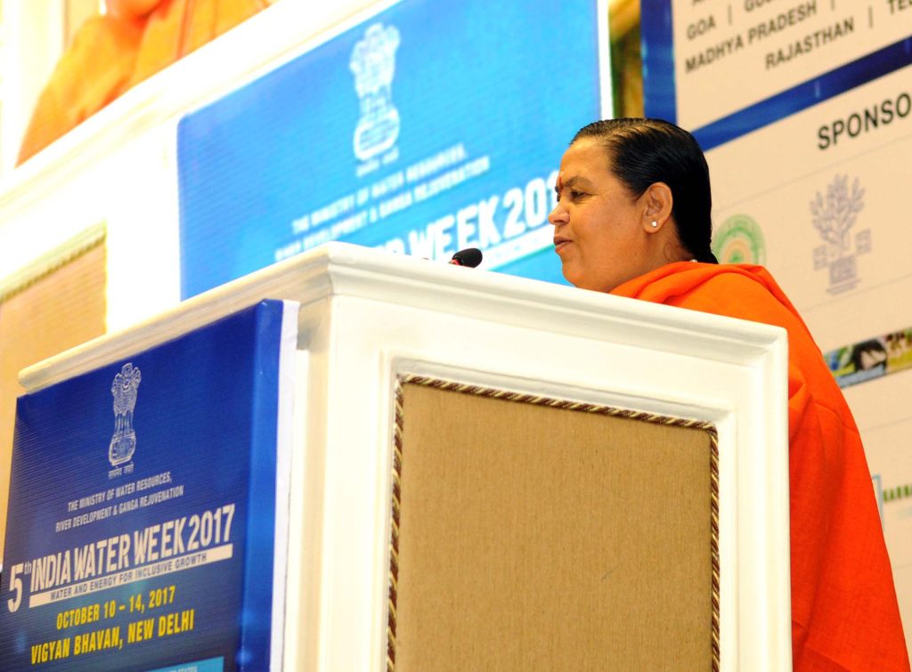 Uma Bharti in saffron robes speaking at a lectern at India Water Week