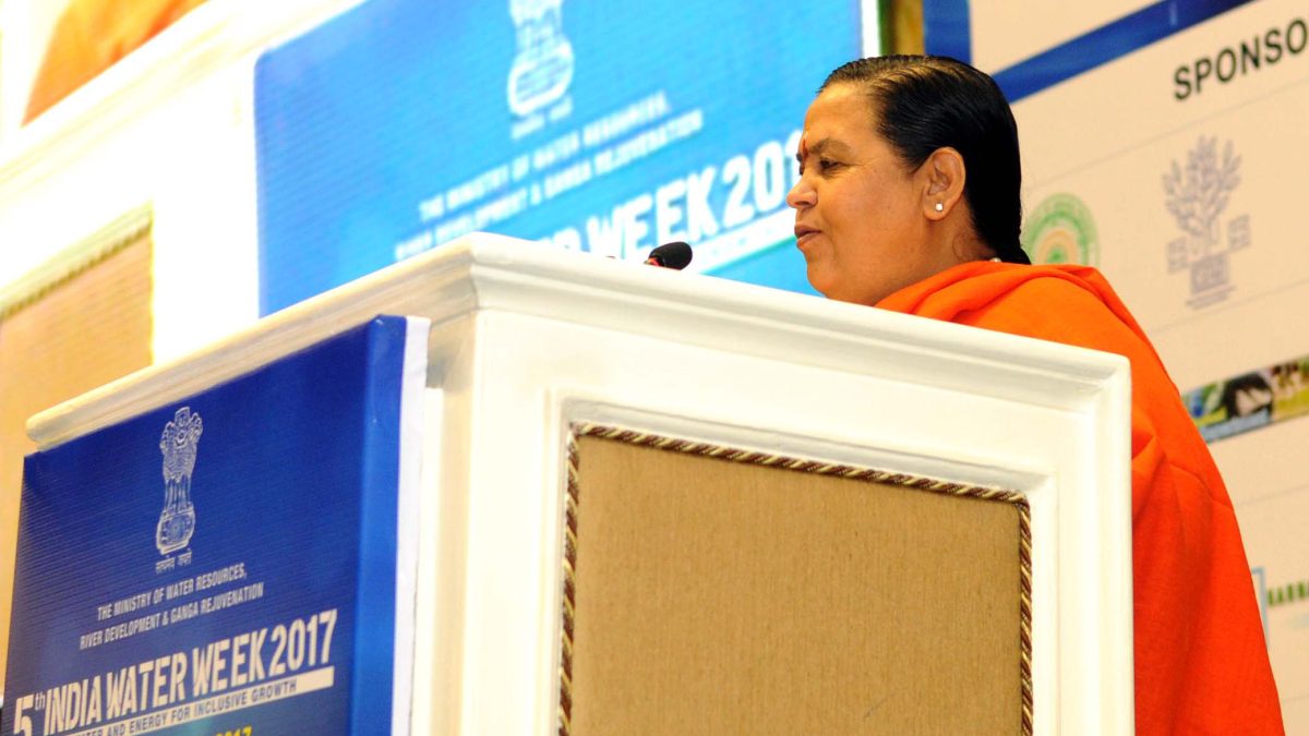 Uma Bharti in saffron robes speaking at a lectern at India Water Week