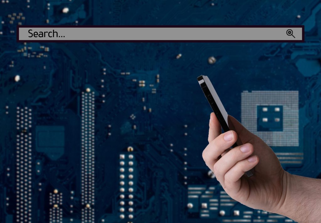 A hand holding a smartphone with a search bar