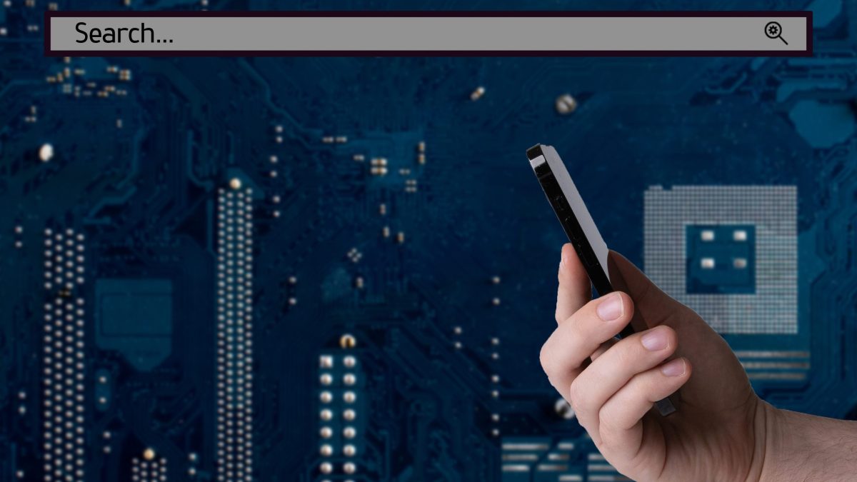 A hand holding a smartphone with a search bar