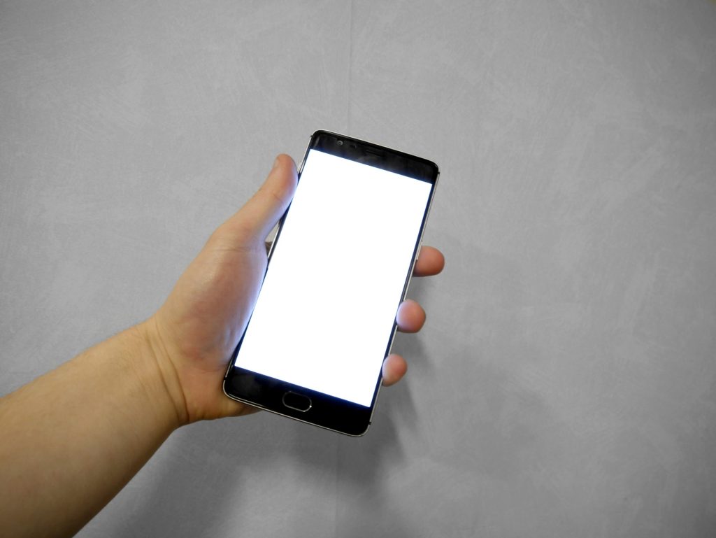 A hand holding a smartphone