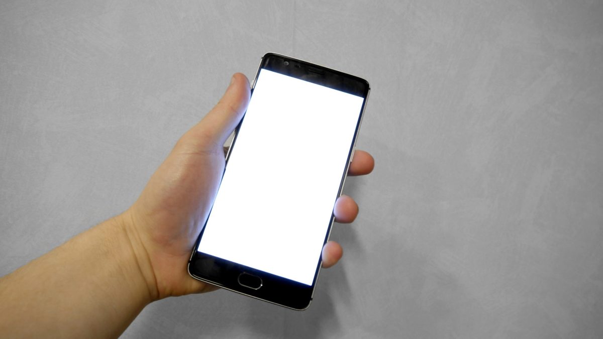 A hand holding a smartphone