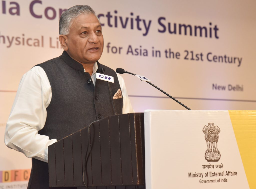 V. K. Singh in a dark waistcoat speaking at a Ministry of External Affairs lectern