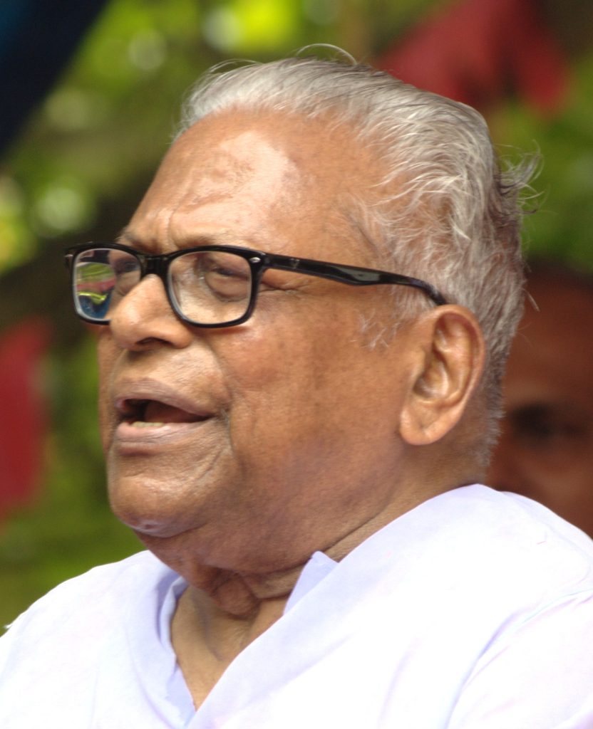 V. S. Achuthanandan with white hair and black-framed glasses, speaking