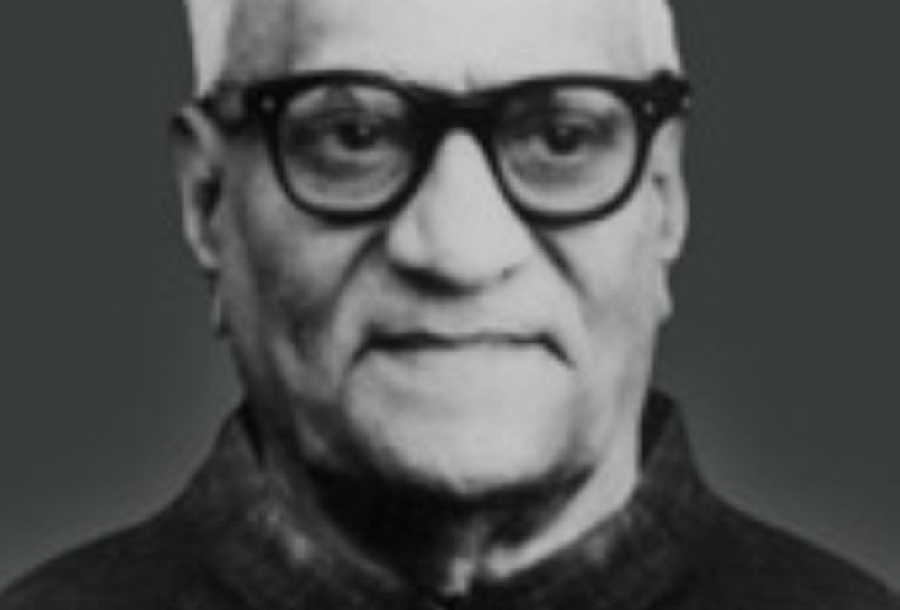 A black-and-white portrait of V. V. Giri in glasses and a dark coat